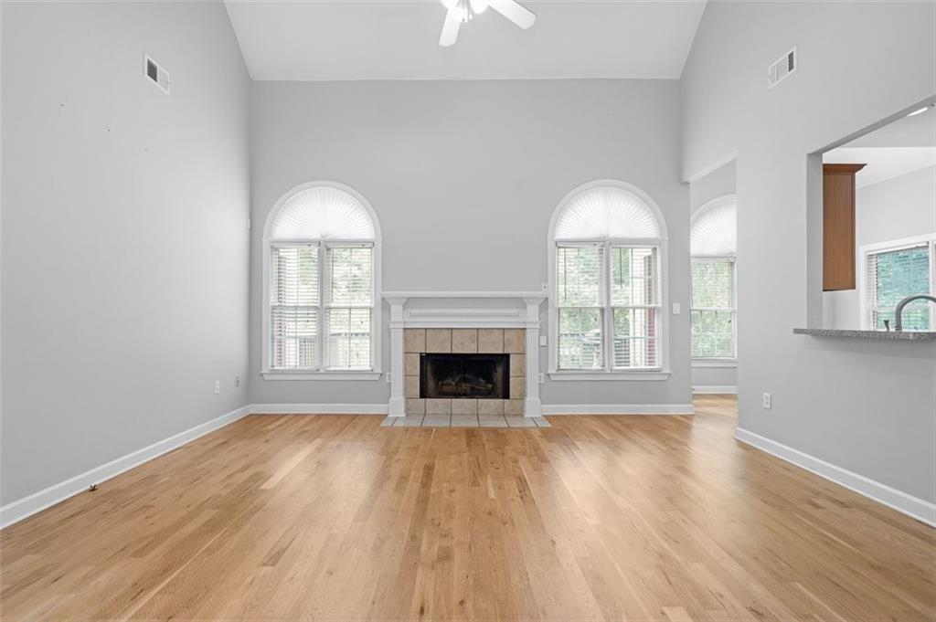 2313 Manor Avenue Atlanta, GA 30344 - Photo 3 of 31 a view of an empty room with wooden floor fireplace and a window