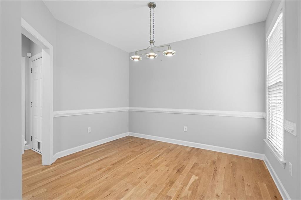 2313 Manor Avenue Atlanta, GA 30344 - Photo 5 of 31 wooden floor in an empty room with a window