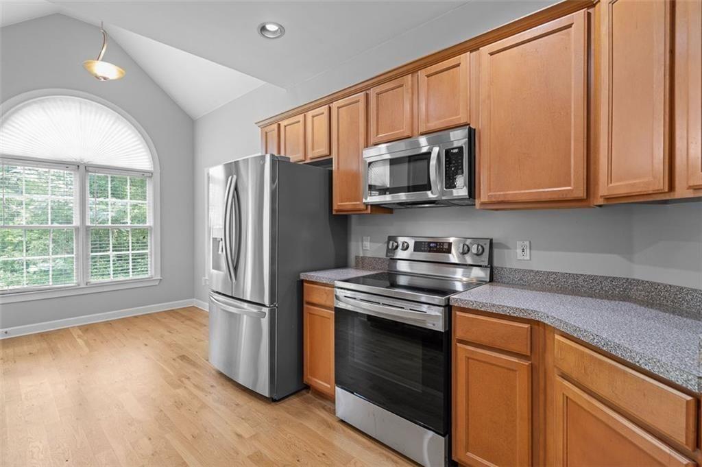 2313 Manor Avenue Atlanta, GA 30344 - Photo 8 of 31 a kitchen with stainless steel appliances granite countertop a stove a refrigerator and a microwave