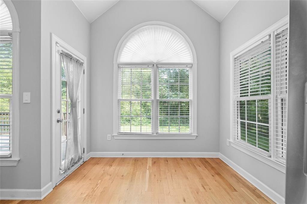 2313 Manor Avenue Atlanta, GA 30344 - Photo 10 of 31 an empty room with wooden floor and windows