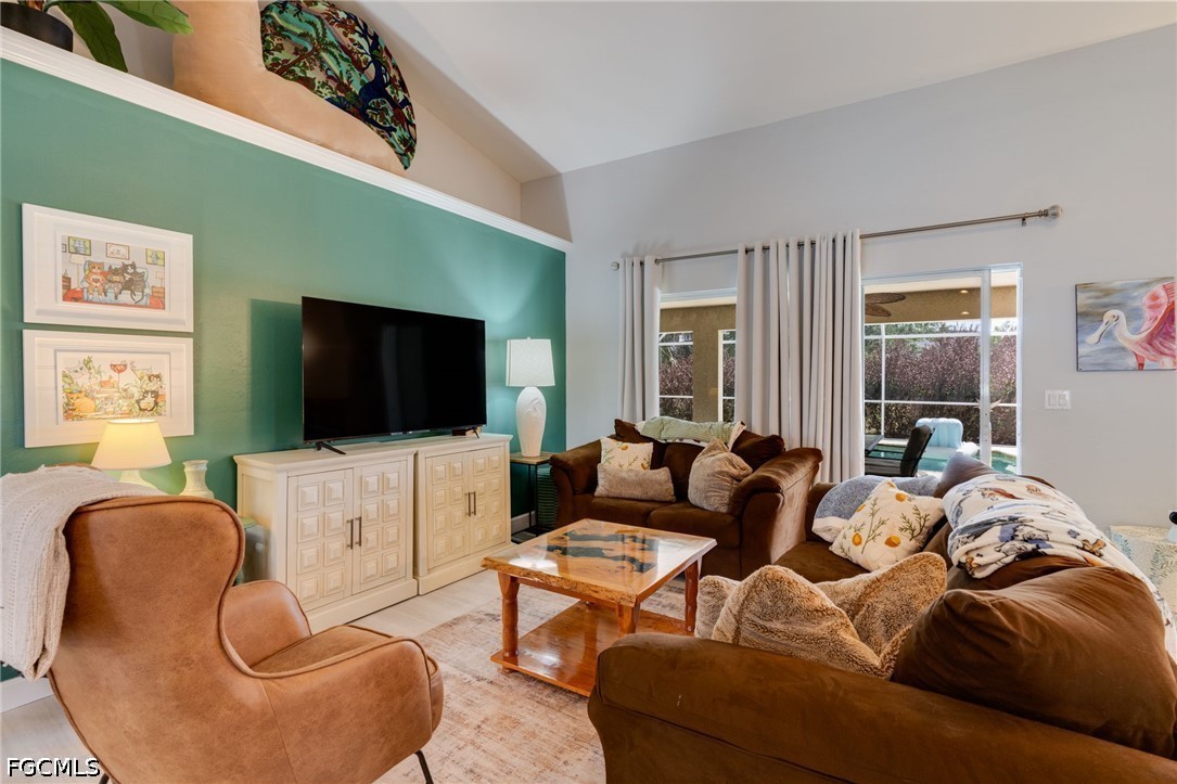 3801 28th Street Southwest Lehigh Acres, FL 33976 - Photo 5 of 37 a living room with furniture and a flat screen tv