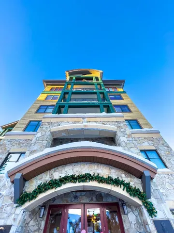 a view of a balcony with a bed and a table