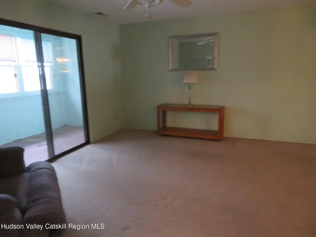 a view of an empty room and a window