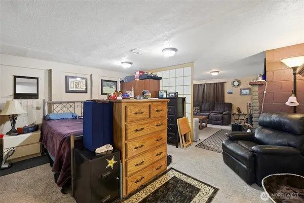 a view of a livingroom with furniture and a flat screen tv