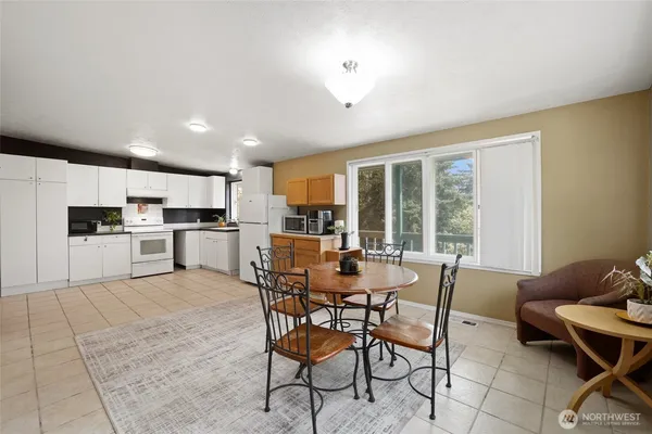 a view of a dining room with furniture and a kitchen