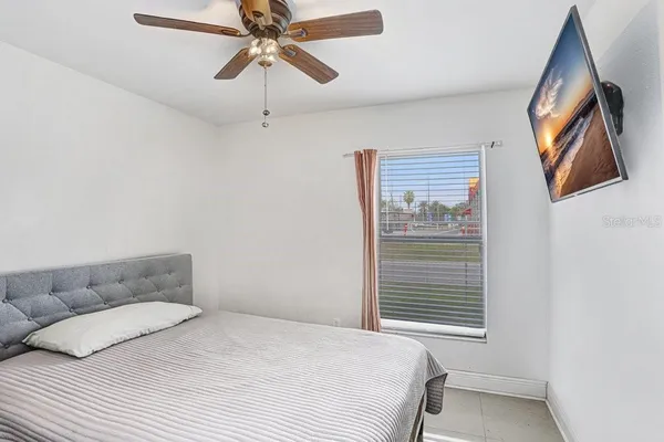 a bedroom with a bed and a window
