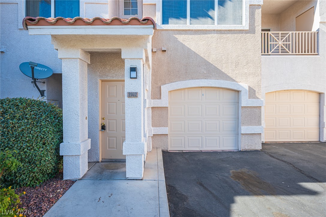 8555 West Russell Road, Unit 2062 Las Vegas, NV 89113 - Photo 2 of 35 A well-maintained stucco facade boasts an inviting entry and convenient attached garages.