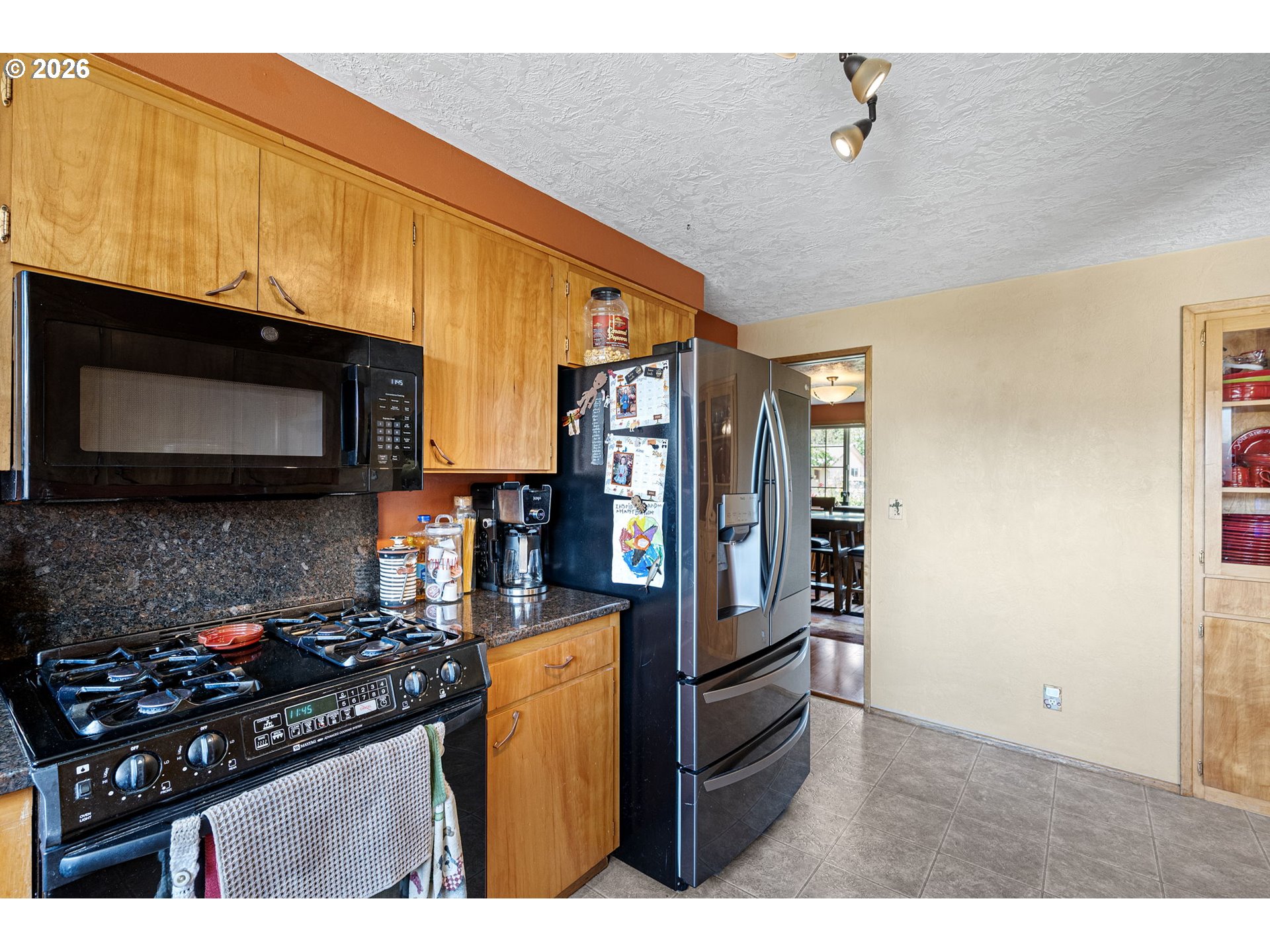 2465 17th Street Springfield, OR 97477 - Photo 17 of 47 a kitchen with stainless steel appliances a sink a stove cabinets and a microwave
