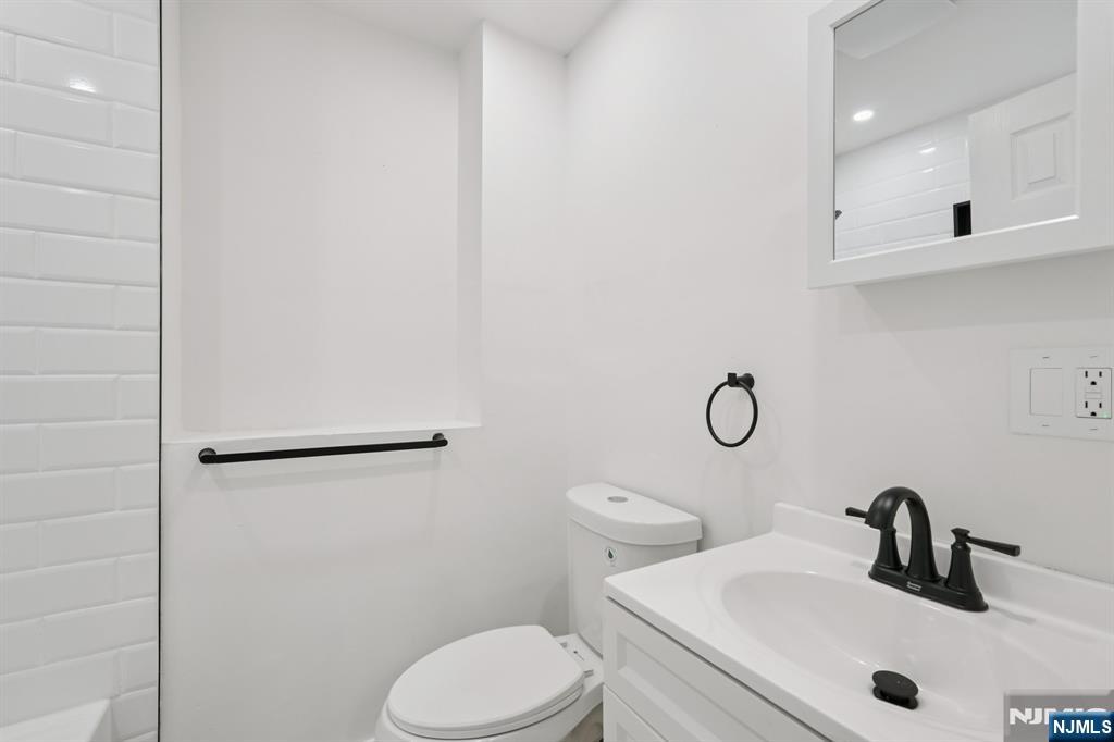 185 James Street, Unit 2 Hackensack, NJ 07601 - Photo 13 of 21 a bathroom with a sink a toilet and shower