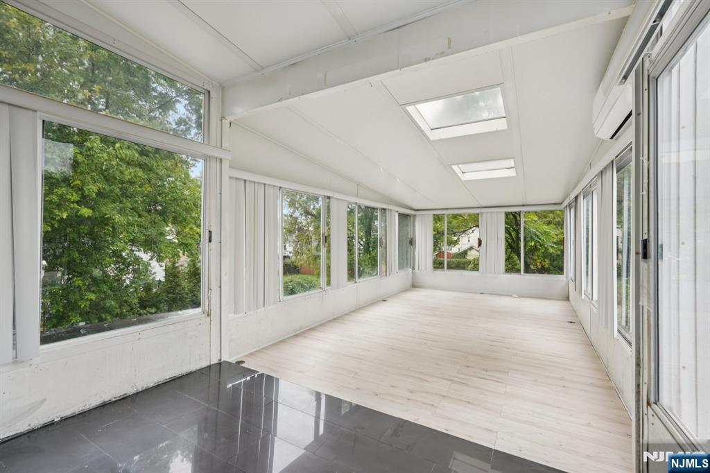 185 James Street, Unit 2 Hackensack, NJ 07601 - Photo 4 of 21 a view of an empty room with wooden floor and a window