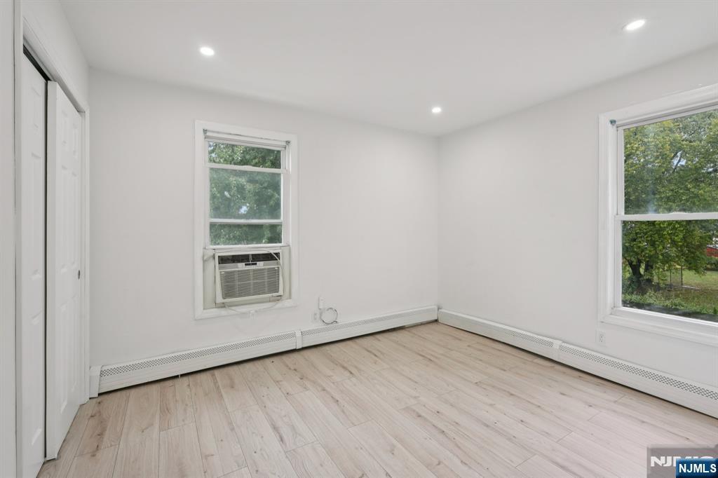185 James Street, Unit 2 Hackensack, NJ 07601 - Photo 8 of 21 an empty room with wooden floor and windows