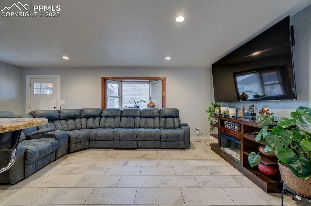 1421 Querida Drive Colorado Springs, CO 80909 - Photo 13 of 49 a living room with furniture and a flat screen tv