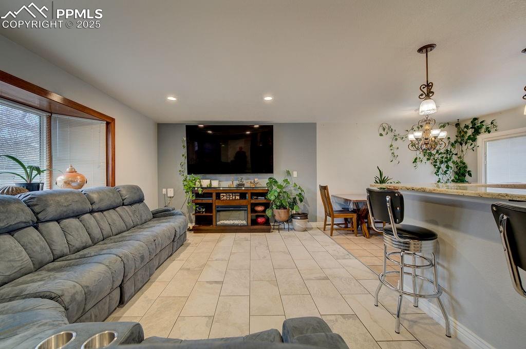 1421 Querida Drive Colorado Springs, CO 80909 - Photo 14 of 49 a living room with furniture and a flat screen tv