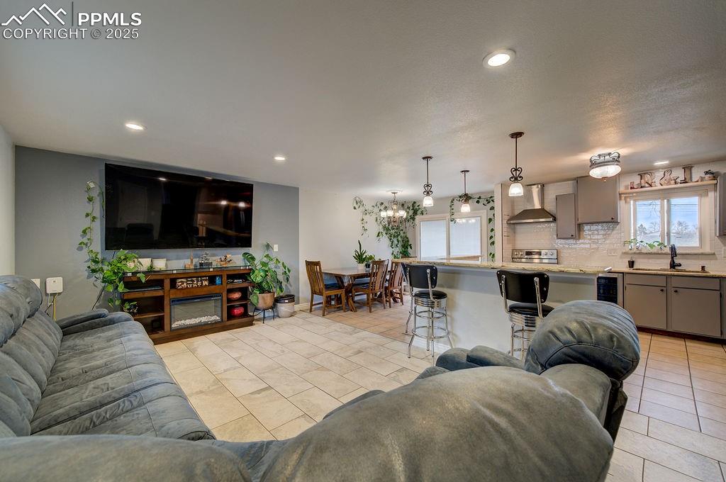 1421 Querida Drive Colorado Springs, CO 80909 - Photo 15 of 49 a living room with furniture and a flat screen tv