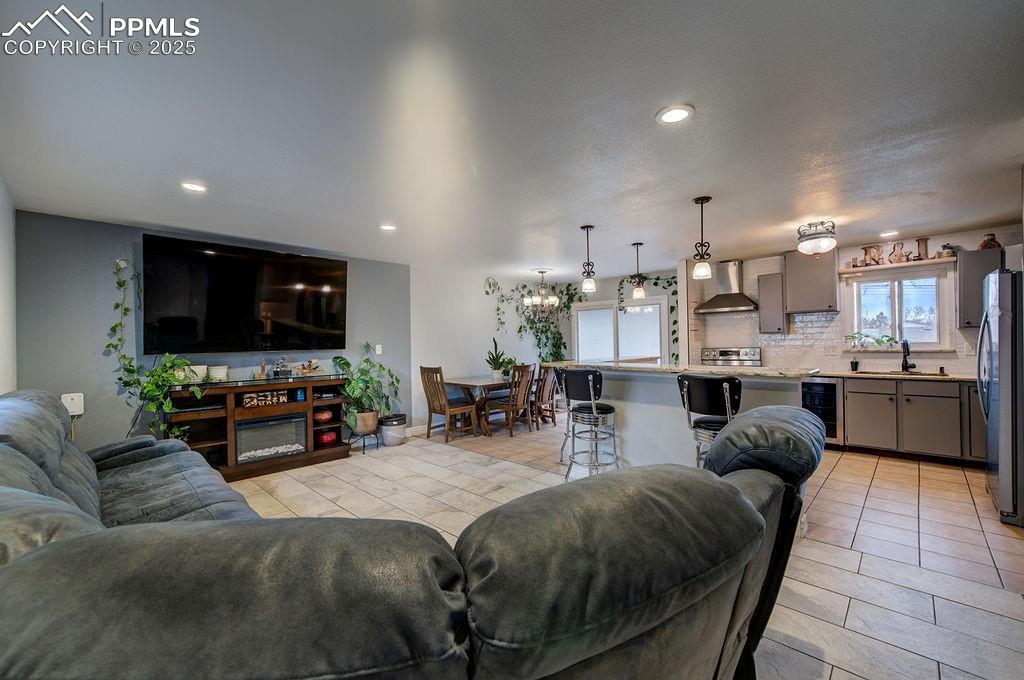 1421 Querida Drive Colorado Springs, CO 80909 - Photo 16 of 49 a living room with furniture and a flat screen tv