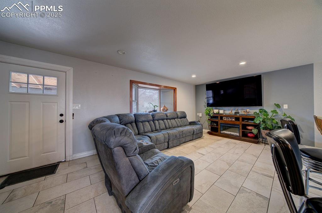 1421 Querida Drive Colorado Springs, CO 80909 - Photo 17 of 49 a living room with furniture and a flat screen tv