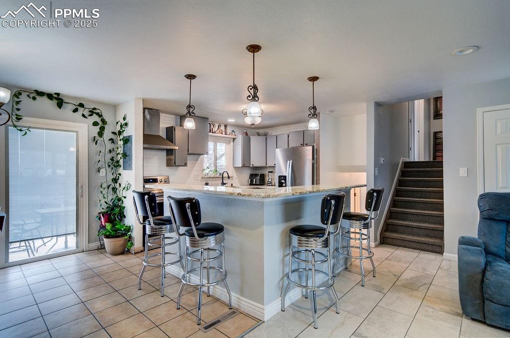 1421 Querida Drive Colorado Springs, CO 80909 - Photo 19 of 49 a view of kitchen with dining area windows and chairs