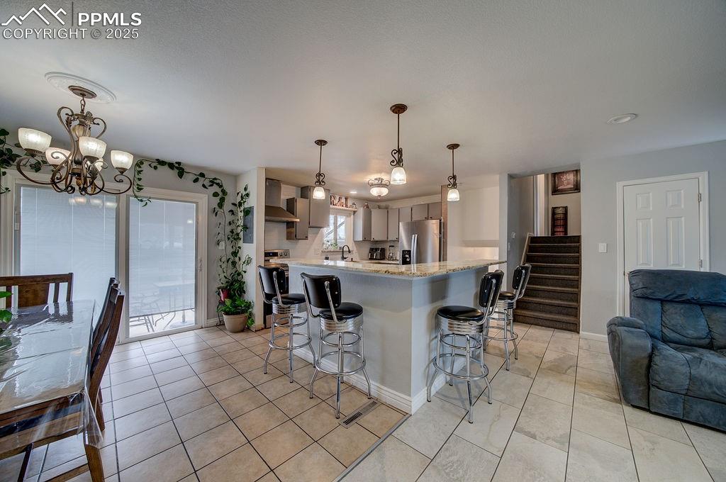 1421 Querida Drive Colorado Springs, CO 80909 - Photo 20 of 49 a dining room with furniture and wooden floor