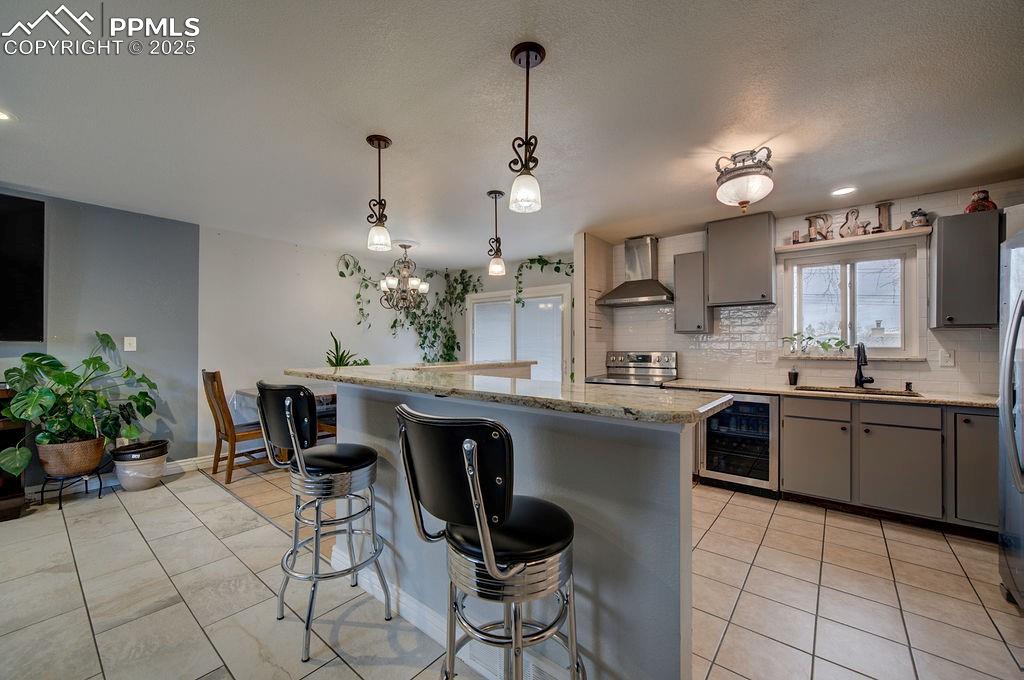 1421 Querida Drive Colorado Springs, CO 80909 - Photo 22 of 49 a kitchen with kitchen island granite countertop a sink counter top space appliances and cabinets