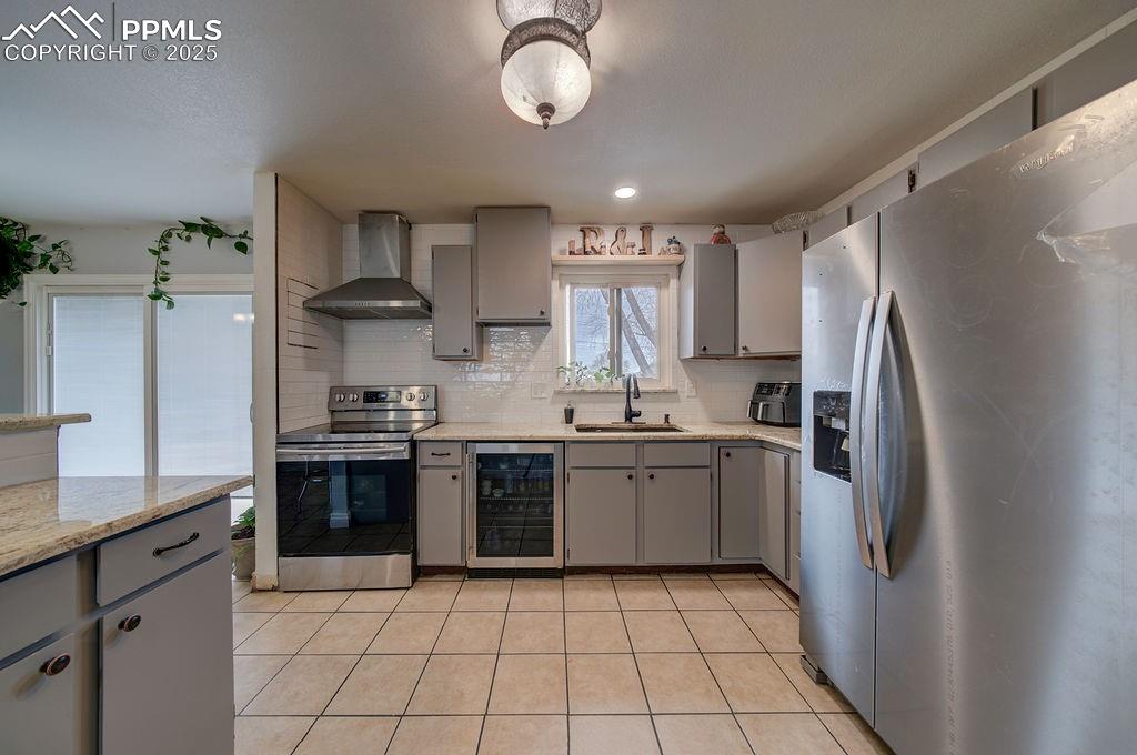 1421 Querida Drive Colorado Springs, CO 80909 - Photo 27 of 49 a kitchen with stainless steel appliances granite countertop a sink stove and refrigerator