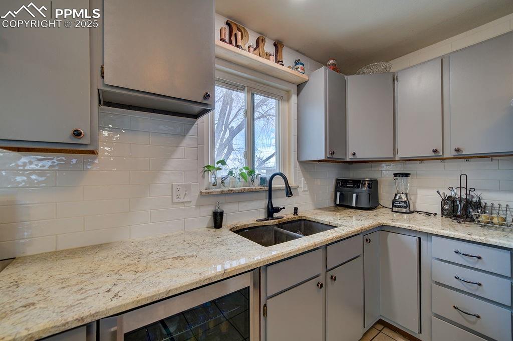1421 Querida Drive Colorado Springs, CO 80909 - Photo 28 of 49 a kitchen with a sink cabinets and window