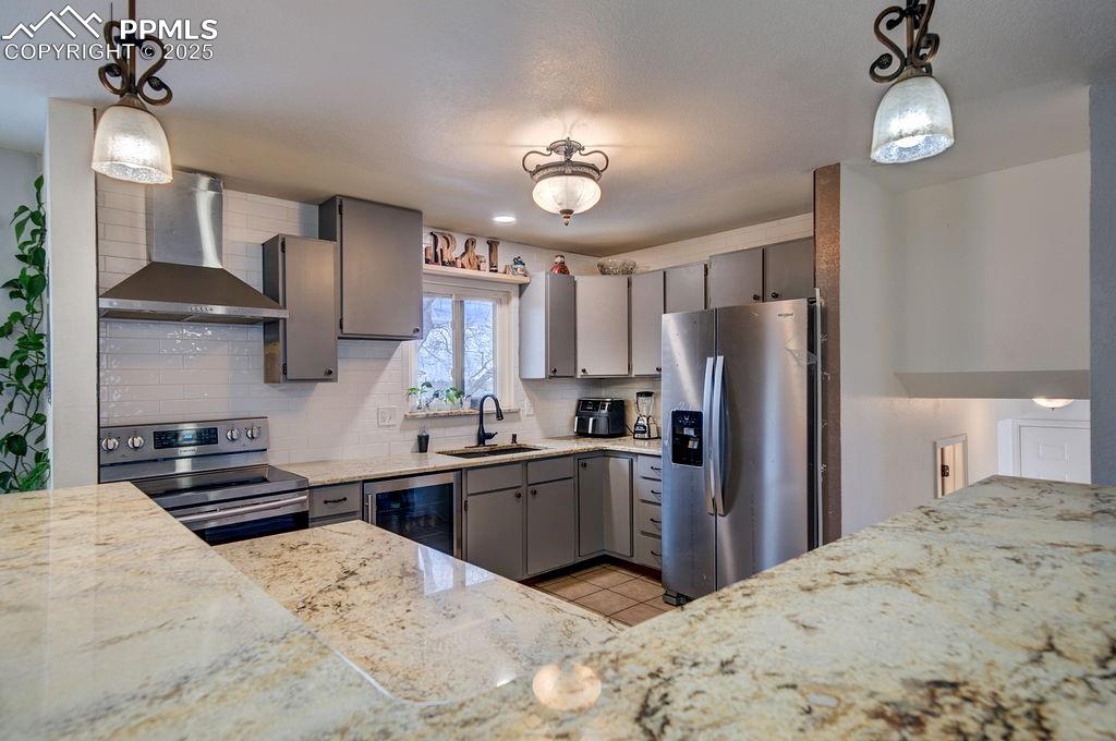1421 Querida Drive Colorado Springs, CO 80909 - Photo 31 of 49 a kitchen with stainless steel appliances kitchen island granite countertop a refrigerator stove top oven and sink