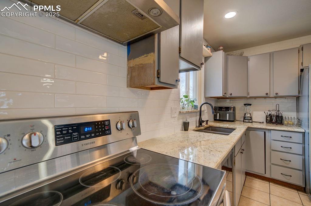 1421 Querida Drive Colorado Springs, CO 80909 - Photo 32 of 49 a kitchen with granite countertop stainless steel appliances and wooden cabinets