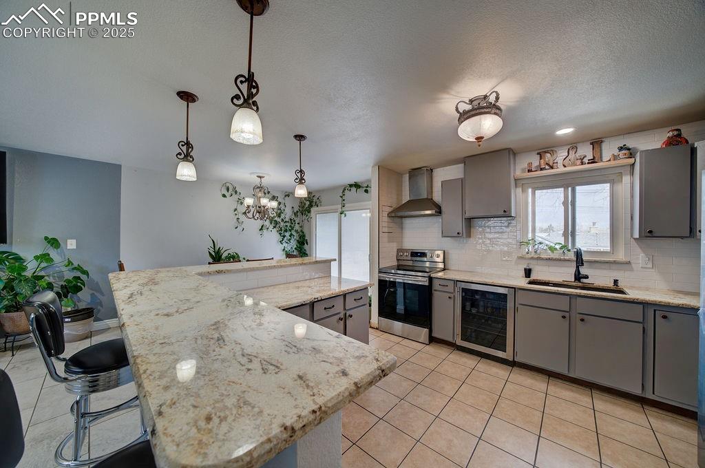 1421 Querida Drive Colorado Springs, CO 80909 - Photo 33 of 49 a kitchen with stainless steel appliances kitchen island granite countertop a sink and cabinets