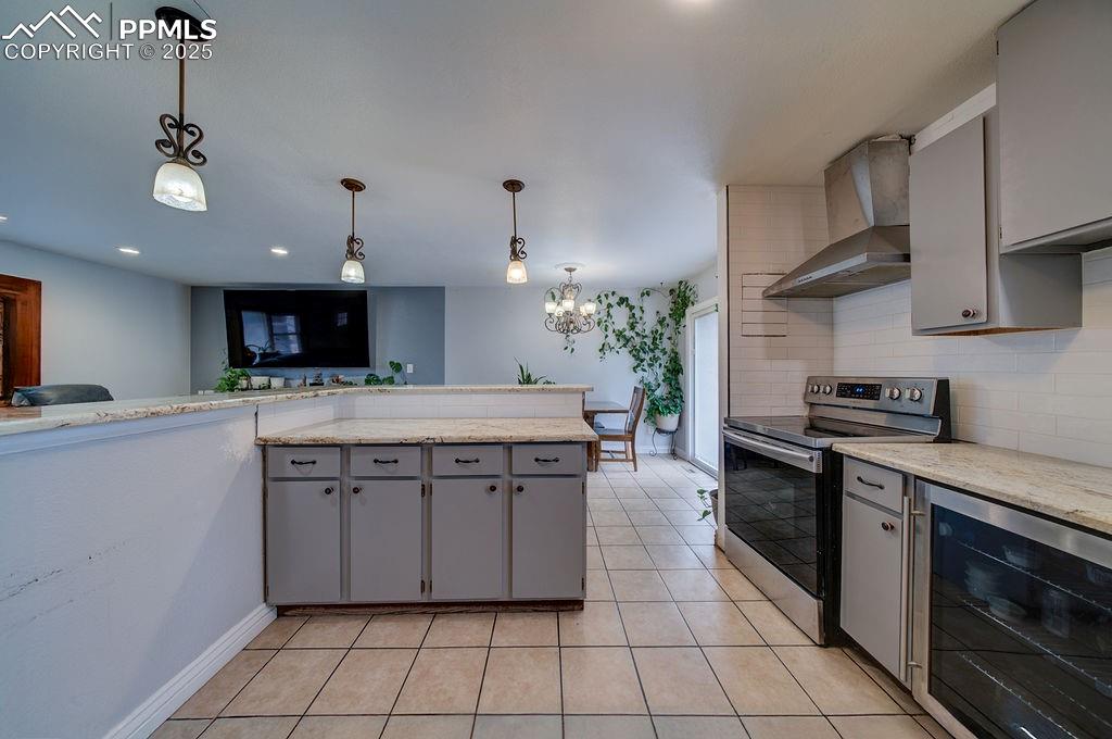 1421 Querida Drive Colorado Springs, CO 80909 - Photo 34 of 49 a kitchen with stainless steel appliances granite countertop a stove a sink and a refrigerator