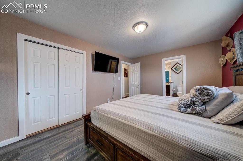 1421 Querida Drive Colorado Springs, CO 80909 - Photo 37 of 49 a bedroom with a bed and a flat screen tv