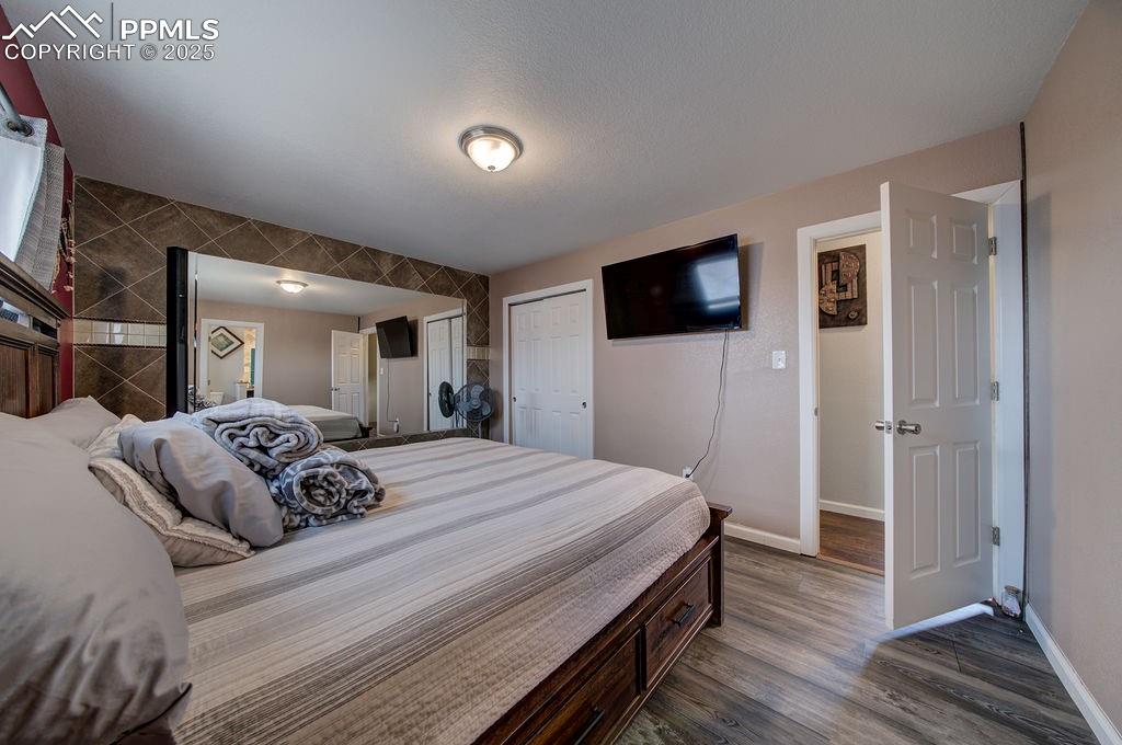 1421 Querida Drive Colorado Springs, CO 80909 - Photo 38 of 49 a bedroom with a bed and a flat screen tv