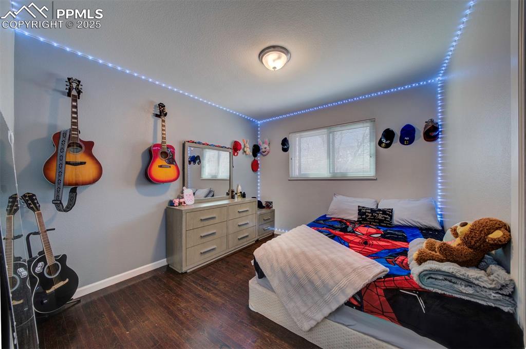 1421 Querida Drive Colorado Springs, CO 80909 - Photo 40 of 49 a bedroom with a bed and cabinets