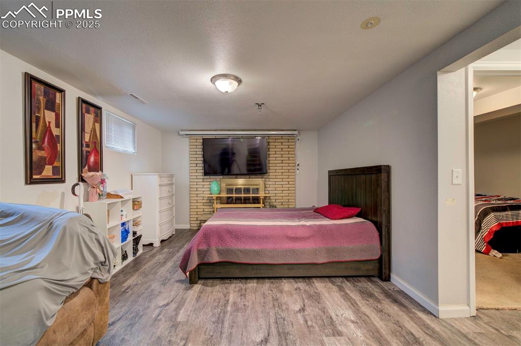 1421 Querida Drive Colorado Springs, CO 80909 - Photo 41 of 49 a bedroom with a bed and a flat screen tv