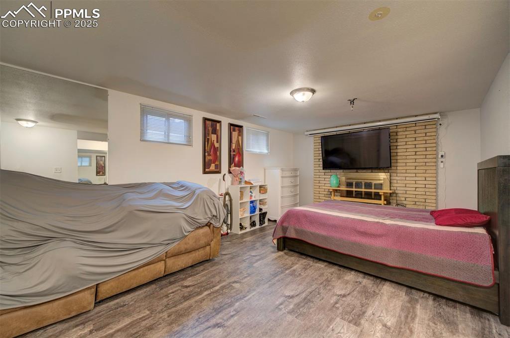 1421 Querida Drive Colorado Springs, CO 80909 - Photo 43 of 49 a bedroom with a bed and a flat screen tv