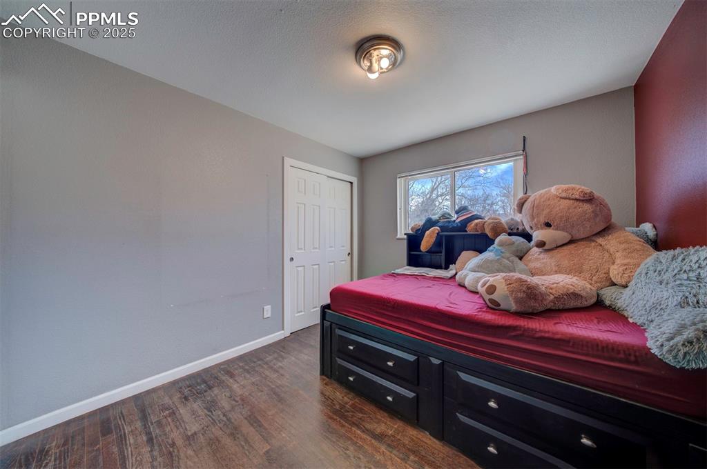 1421 Querida Drive Colorado Springs, CO 80909 - Photo 48 of 49 a bedroom with a bed and a window