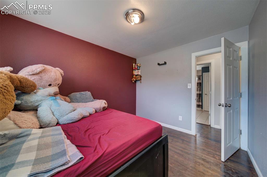 1421 Querida Drive Colorado Springs, CO 80909 - Photo 49 of 49 a bedroom with two beds and a lamp