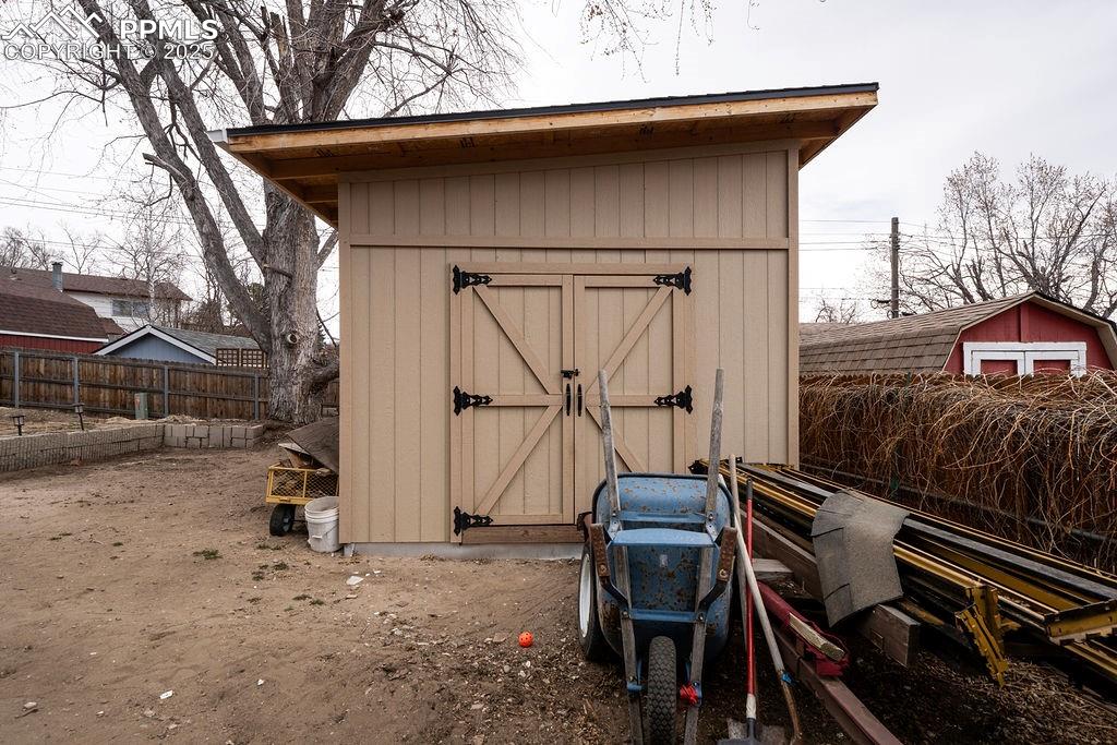 1421 Querida Drive Colorado Springs, CO 80909 - Photo 5 of 49 a backyard of a house with table and chairs