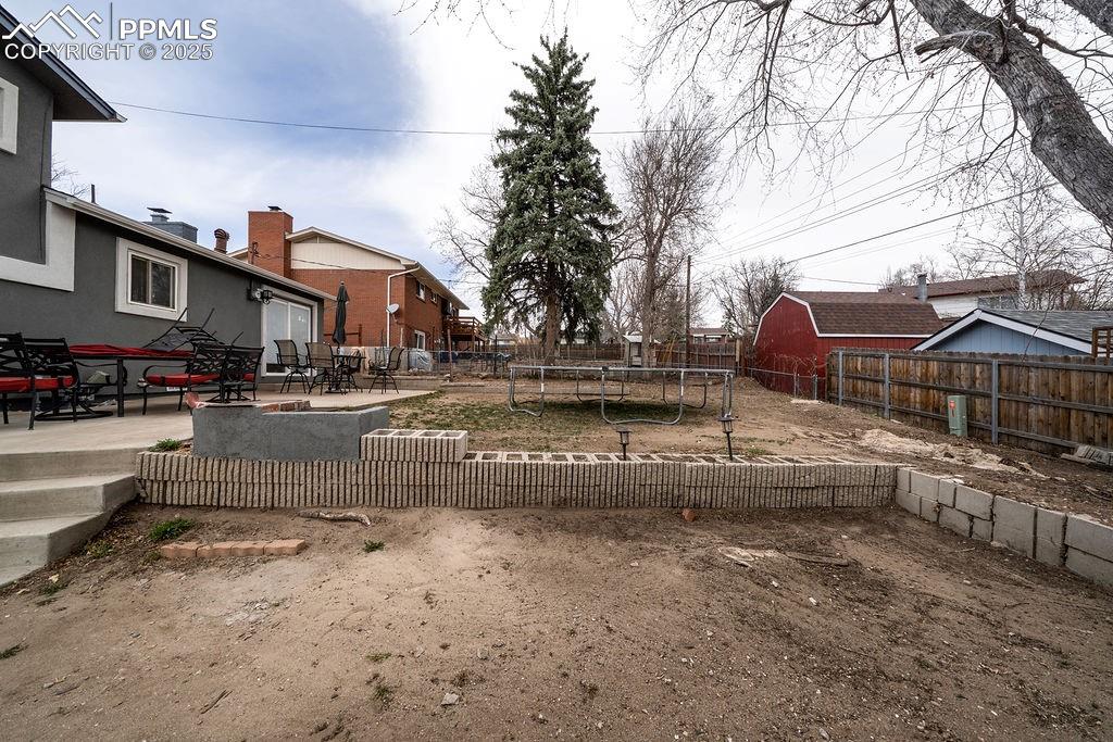 1421 Querida Drive Colorado Springs, CO 80909 - Photo 6 of 49 a front view of a house with a yard