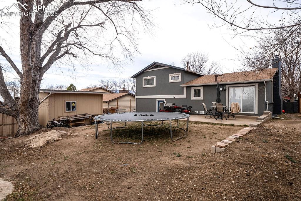 1421 Querida Drive Colorado Springs, CO 80909 - Photo 9 of 49 a view of a house with a yard and sitting area