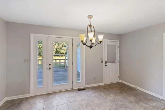 an empty room with windows fireplace and windows