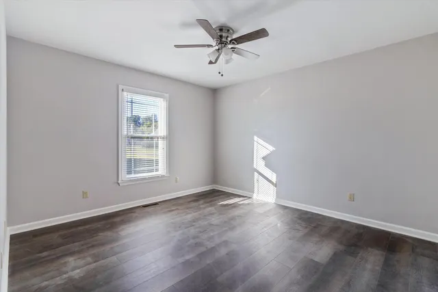 a bathroom with a sink vanity granite and toilet