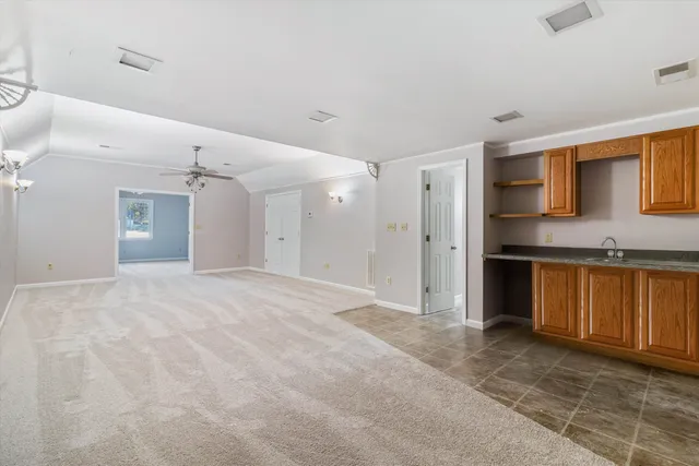 a view of an empty room with a ceiling fan