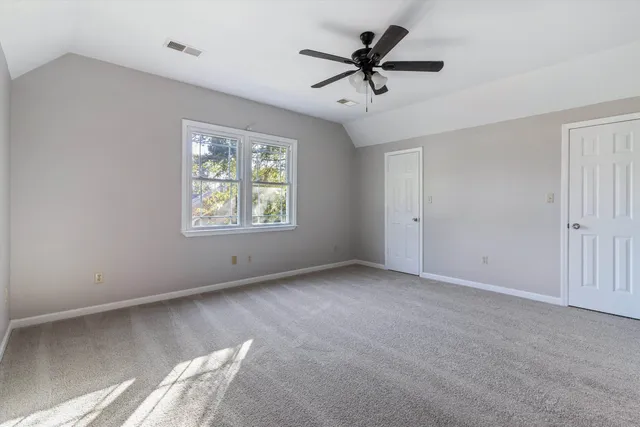 a view of a livingroom with a ceiling fan and window