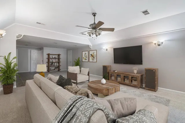 a living room with furniture and a flat screen tv