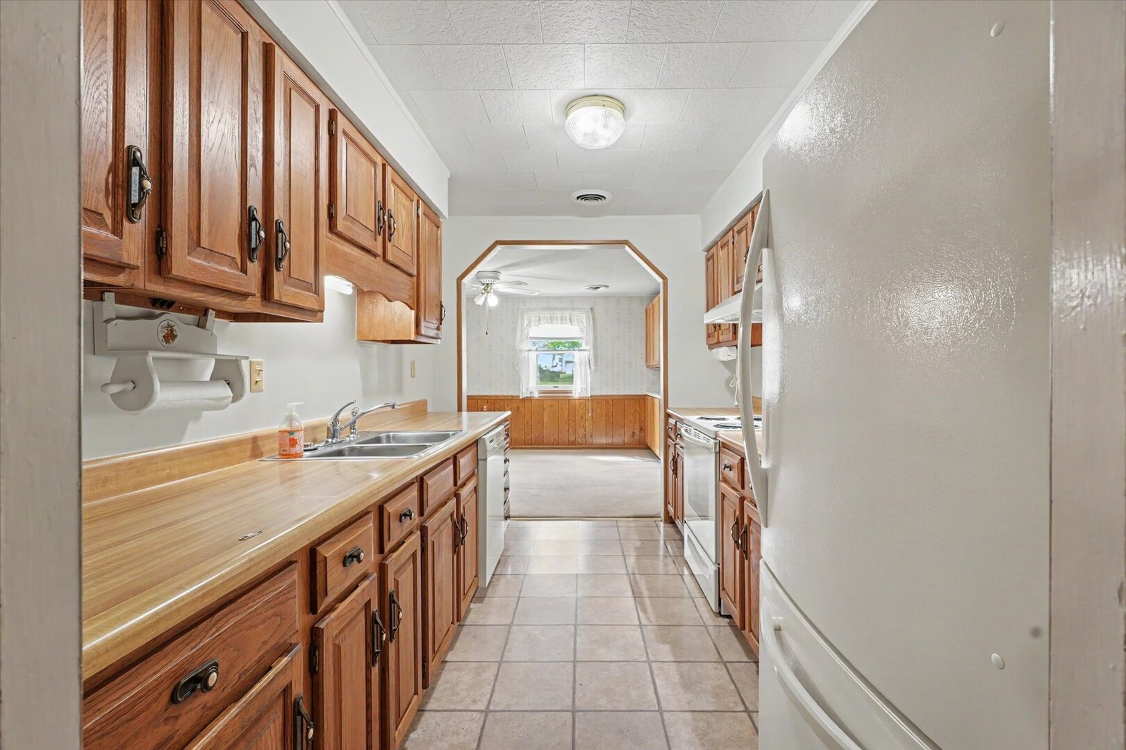517 Illinois Drive Rantoul, IL 61866 - Photo 12 of 37 a kitchen with stainless steel appliances granite countertop a sink and dishwasher a stove with wooden cabinets