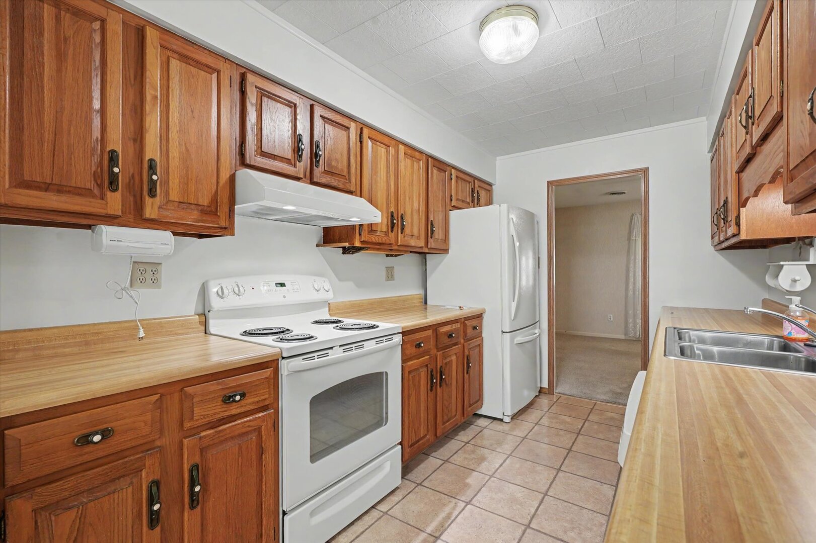 517 Illinois Drive Rantoul, IL 61866 - Photo 14 of 37 a kitchen with stainless steel appliances granite countertop a stove a sink and a refrigerator