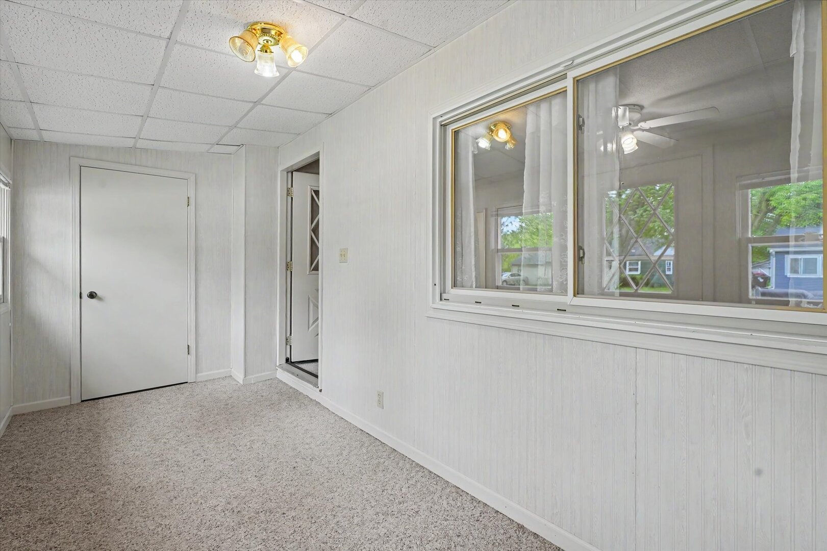 517 Illinois Drive Rantoul, IL 61866 - Photo 7 of 37 a view of a hallway with a large window and chandelier