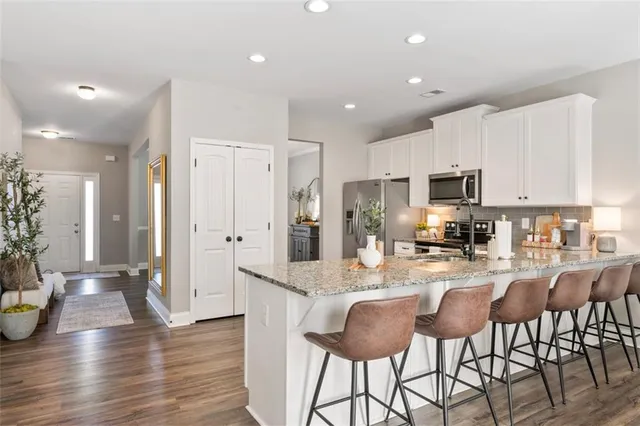 a view of a dining room with furniture and wooden floor