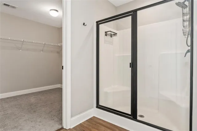 an empty room with a window and a ceiling fan