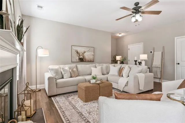 a living room with furniture a fireplace and a chandelier
